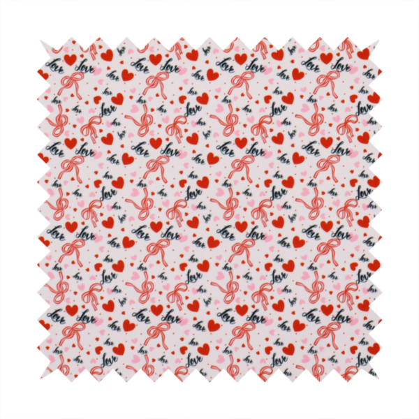 This light pink fabric features a dense, repeating Valentine’s Day pattern with a vintage, romantic aesthetic. The design is composed of small red hearts and larger pink hearts, interspersed with delicate red ribbon bows and the word "love" written in a dark, flowing cursive script. Tiny red dots are scattered throughout the background, creating a textured, confetti-like effect across the entire print.