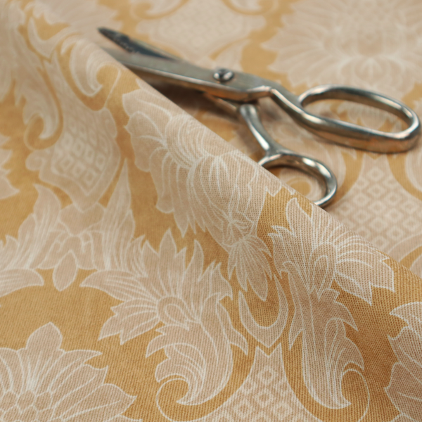 An elegant damask fabric featuring a repeating, symmetrical floral and leaf medallion pattern in cream over a warm ochre-gold background.