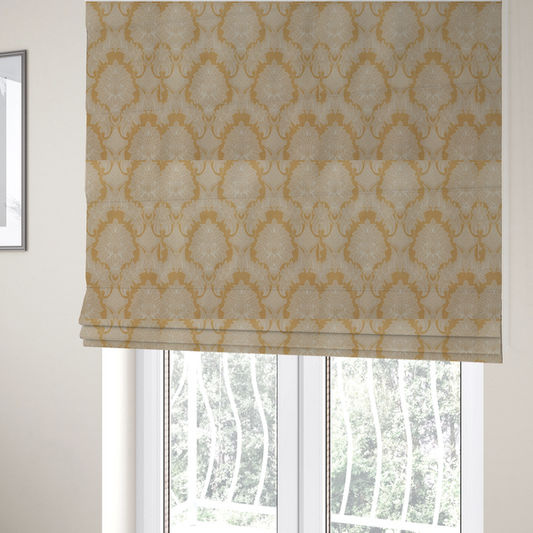 The fabric used to create these Roman blinds is an elegant damask fabric featuring a repeating, symmetrical floral and leaf medallion pattern in cream over a warm ochre-gold background.