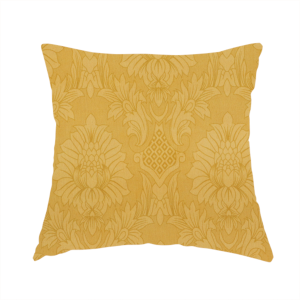The fabric used for this handmade cushion is a luxurious tonal gold damask fabric featuring a repeating symmetrical floral medallion pattern in shimmering amber and matte ochre tones.