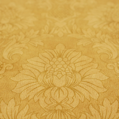Luxurious tonal gold damask fabric featuring a repeating symmetrical floral medallion pattern in shimmering amber and matte ochre tones.
