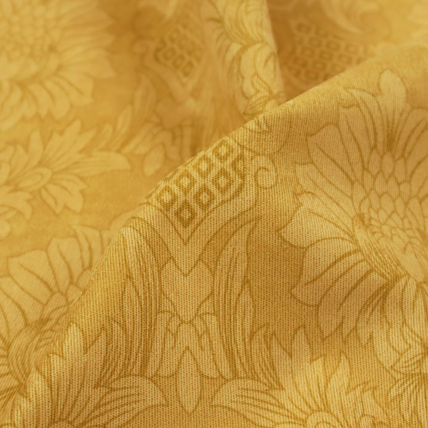 Luxurious tonal gold damask fabric featuring a repeating symmetrical floral medallion pattern in shimmering amber and matte ochre tones.