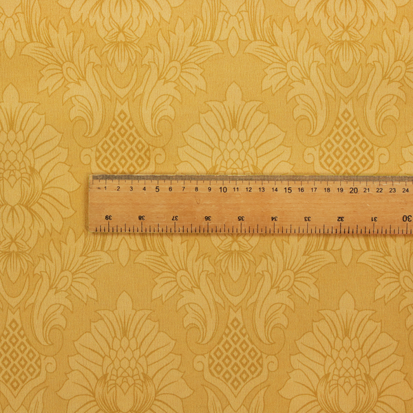 Luxurious tonal gold damask fabric featuring a repeating symmetrical floral medallion pattern in shimmering amber and matte ochre tones.