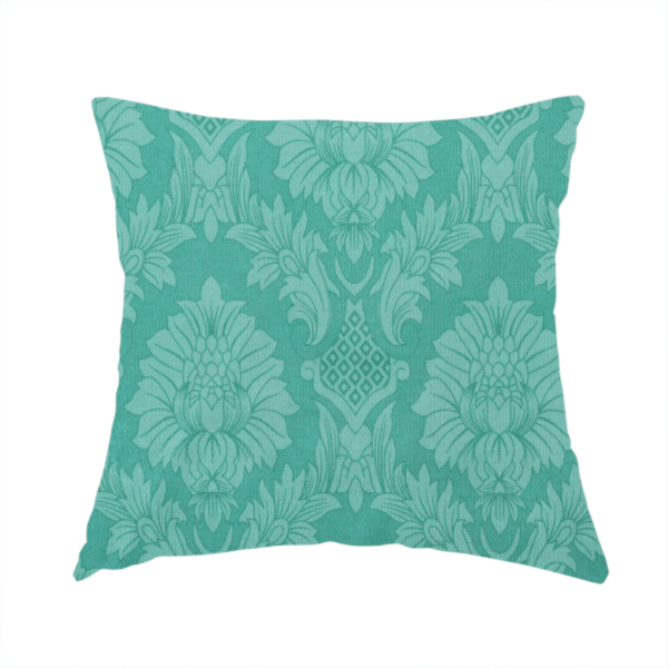 The fabric used to create this handmade cushion is a vibrant teal damask fabric featuring a large-scale, repeating floral and acanthus leaf pattern in a tonal, monochromatic seafoam green colourway.