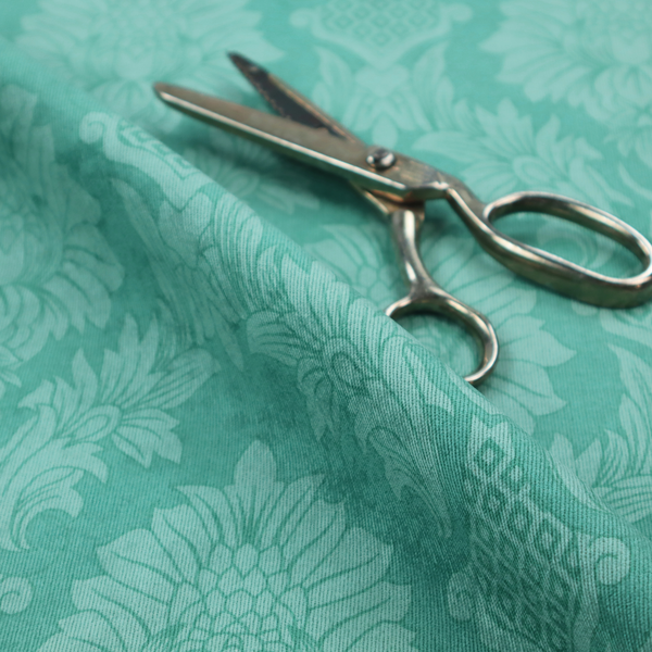 Vibrant teal damask fabric featuring a large-scale, repeating floral and acanthus leaf pattern in a tonal, monochromatic seafoam green colourway.