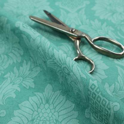 Vibrant teal damask fabric featuring a large-scale, repeating floral and acanthus leaf pattern in a tonal, monochromatic seafoam green colourway.