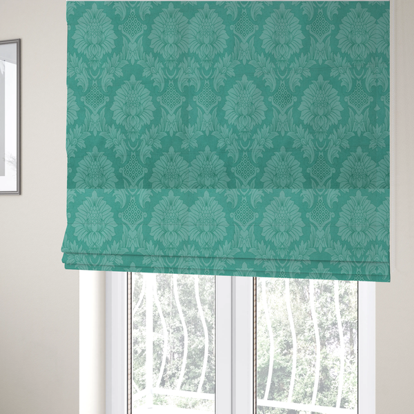 The fabric used to create these Roman blinds is a vibrant teal damask fabric featuring a large-scale, repeating floral and acanthus leaf pattern in a tonal, monochromatic seafoam green colourway.