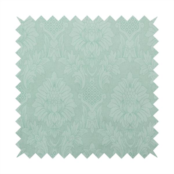 Pale ice blue damask fabric with a subtle, low-contrast floral medallion pattern in light pastel tones.
