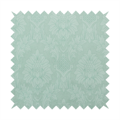 Pale ice blue damask fabric with a subtle, low-contrast floral medallion pattern in light pastel tones.