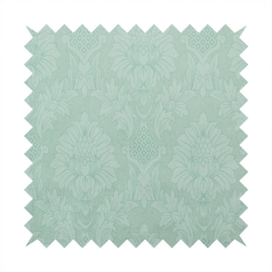 Pale ice blue damask fabric with a subtle, low-contrast floral medallion pattern in light pastel tones.
