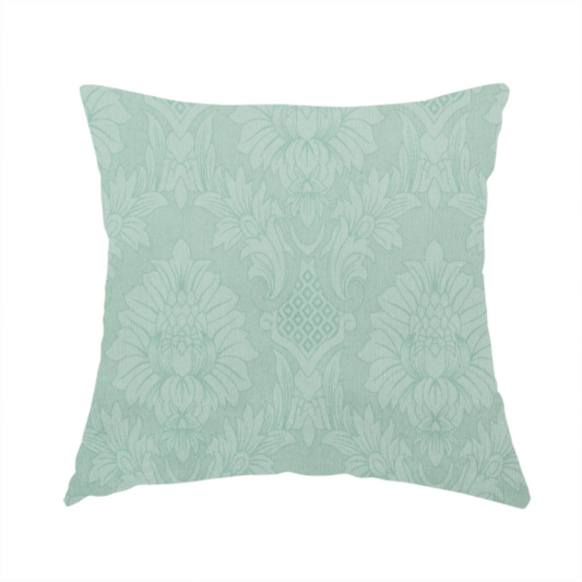 The fabric used to create this handmade cushion is a pale ice blue damask fabric with a subtle, low-contrast floral medallion pattern in light pastel tones.