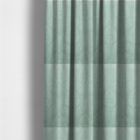 The fabric used to create these made-to-measure curtains is a pale ice blue damask fabric with a subtle, low-contrast floral medallion pattern in light pastel tones.