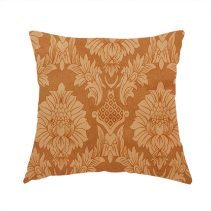 The fabric used to create this handmade cushion is a warm brown damask fabric featuring a large-scale, repeating floral and acanthus leaf pattern in shimmering copper tones.
