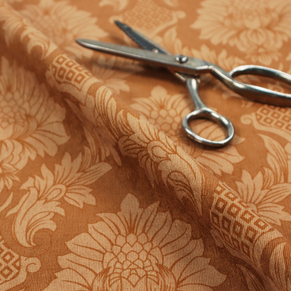 Warm brown damask fabric featuring a large-scale, repeating floral and acanthus leaf pattern in shimmering copper tones.