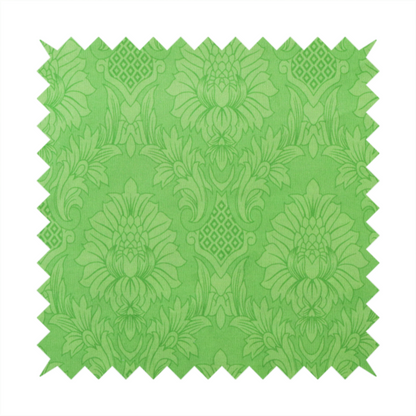 Vibrant apple green damask fabric featuring a repeating, large-scale floral medallion and acanthus leaf pattern in a tonal monochromatic colourway