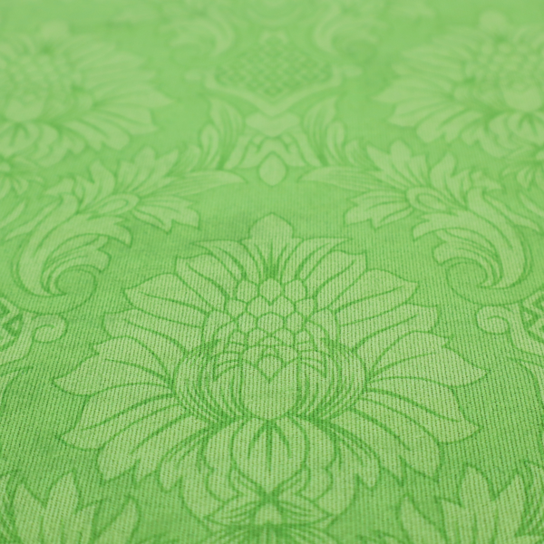 Vibrant apple green damask fabric featuring a repeating, large-scale floral medallion and acanthus leaf pattern in a tonal monochromatic colourway.