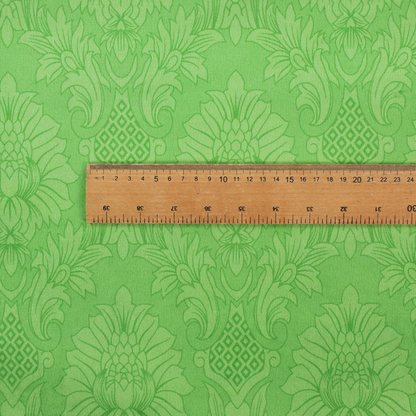 Vibrant apple green damask fabric featuring a repeating, large-scale floral medallion and acanthus leaf pattern in a tonal monochromatic colourway.