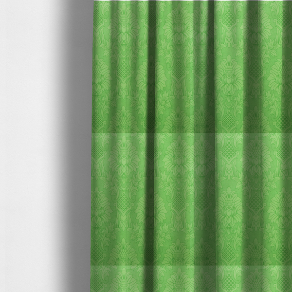 The fabric used to create these made-to-measure curtains is a vibrant apple green damask fabric featuring a repeating, large-scale floral medallion and acanthus leaf pattern in a tonal monochromatic colourway
