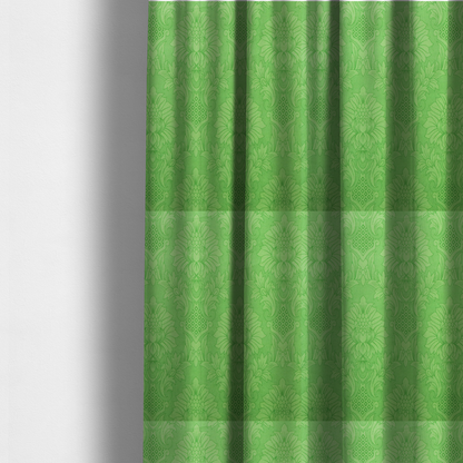 The fabric used to create these made-to-measure curtains is a vibrant apple green damask fabric featuring a repeating, large-scale floral medallion and acanthus leaf pattern in a tonal monochromatic colourway