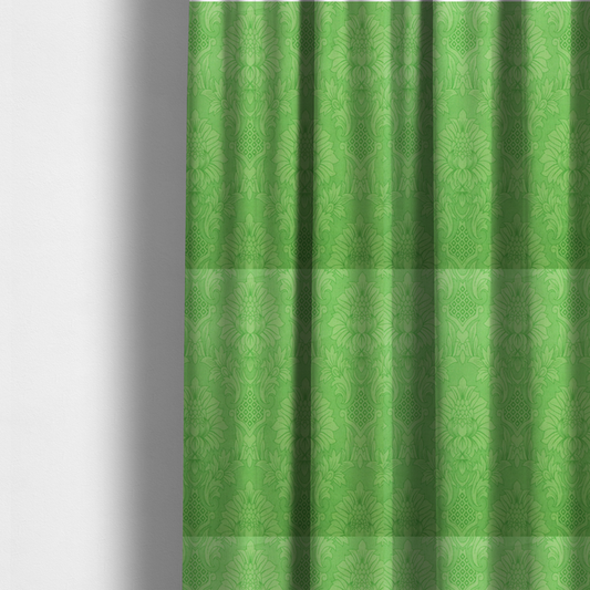 The fabric used to create these made-to-measure curtains is a vibrant apple green damask fabric featuring a repeating, large-scale floral medallion and acanthus leaf pattern in a tonal monochromatic colourway