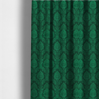 The fabric used to create these made-to-measure curtains is a deep emerald green damask fabric featuring a large-scale, repeating floral and acanthus leaf pattern in a rich tonal colourway.