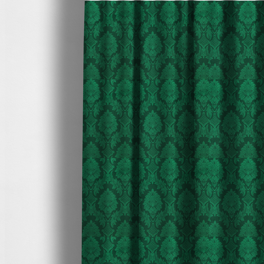 The fabric used to create these made-to-measure curtains is a deep emerald green damask fabric featuring a large-scale, repeating floral and acanthus leaf pattern in a rich tonal colourway.