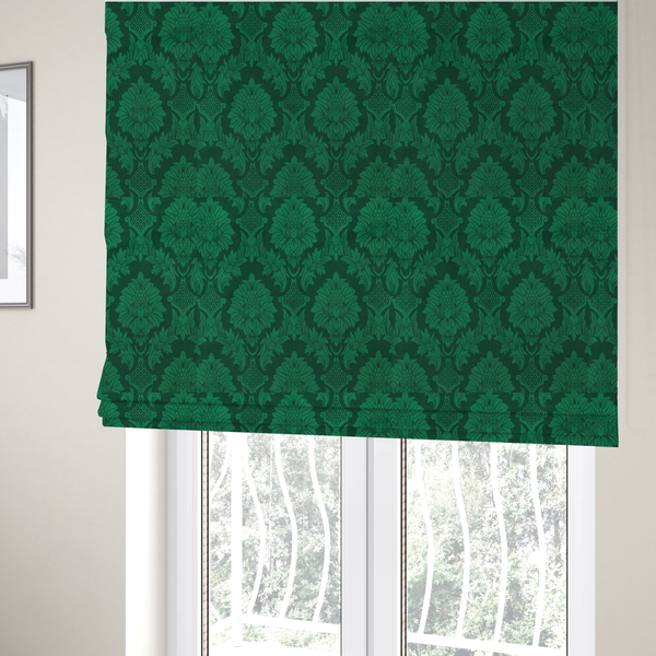 The fabric used to create these Roman blinds is a deep emerald green damask fabric featuring a large-scale, repeating floral and acanthus leaf pattern in a rich tonal colourway.