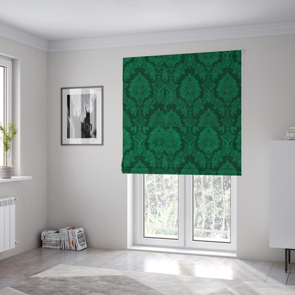 The fabric used to create these Roman blinds is a deep emerald green damask fabric featuring a large-scale, repeating floral and acanthus leaf pattern in a rich tonal colourway.