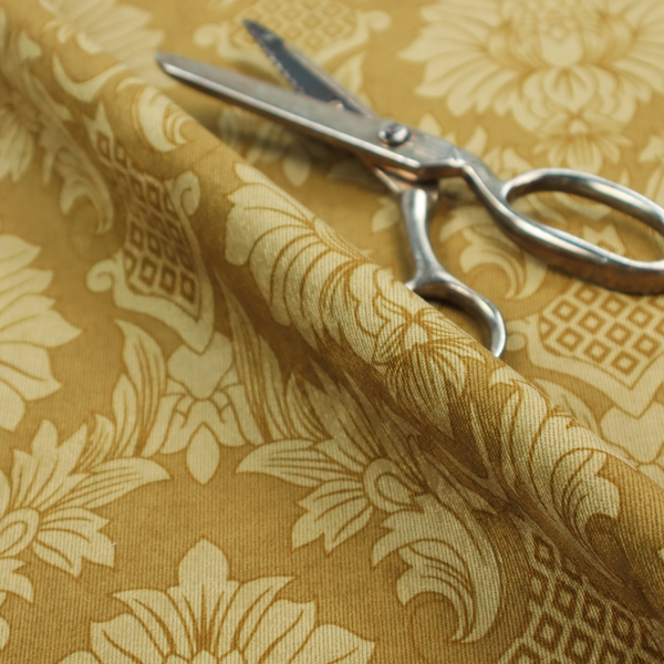 High-contrast damask fabric featuring a shimmering champagne-gold floral medallion pattern over a matte antique bronze background.