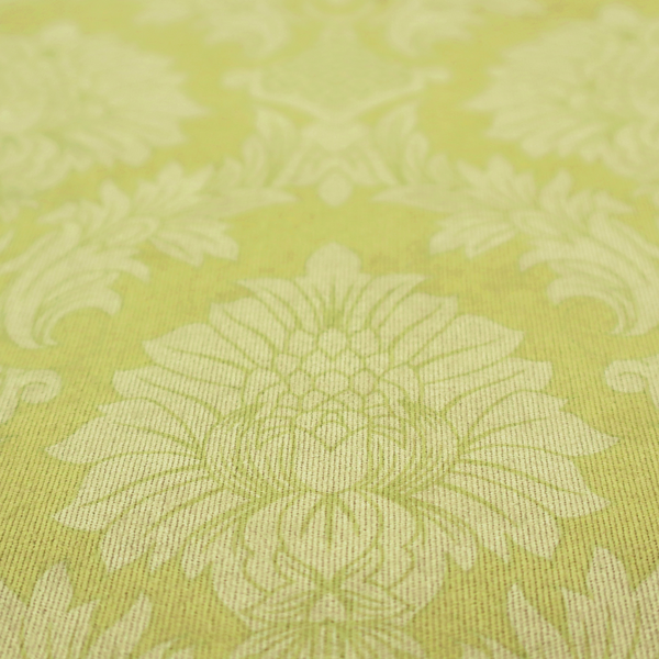 Bright lime-yellow damask fabric featuring a repeating, large-scale floral medallion pattern in a soft tonal colourway.