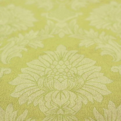 Bright lime-yellow damask fabric featuring a repeating, large-scale floral medallion pattern in a soft tonal colourway.