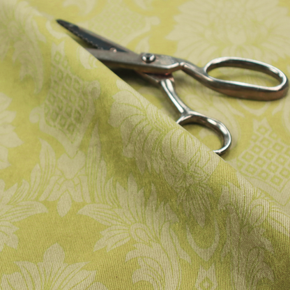 Bright lime-yellow damask fabric featuring a repeating, large-scale floral medallion pattern in a soft tonal colourway.