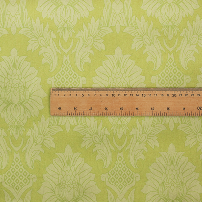 Bright lime-yellow damask fabric featuring a repeating, large-scale floral medallion pattern in a soft tonal colourway.