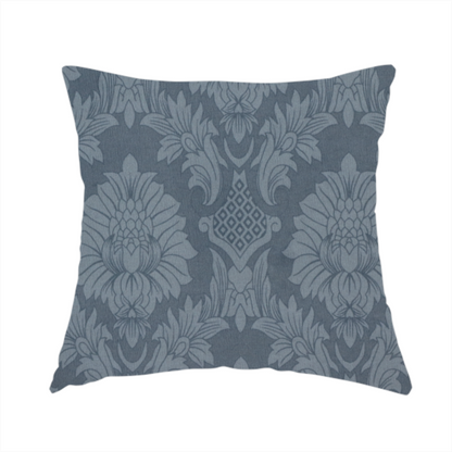 The fabric used to create this handmade cushion is a sophisticated slate blue damask fabric featuring a large-scale, repeating floral and acanthus leaf pattern in a tonal, steel grey colourway.