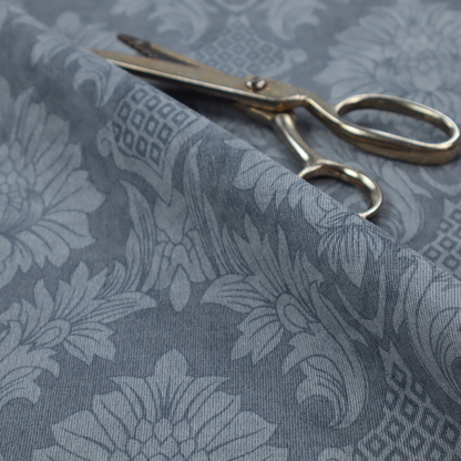 Sophisticated slate blue damask fabric featuring a large-scale, repeating floral and acanthus leaf pattern in a tonal, steel grey colourway.