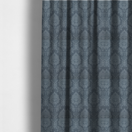The fabric used to create these made-to-measure curtains is a sophisticated slate blue damask fabric featuring a large-scale, repeating floral and acanthus leaf pattern in a tonal, steel grey colourway.