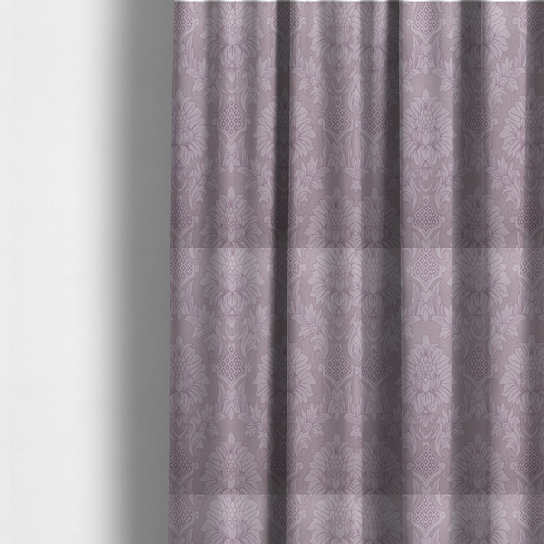 The fabric used to create these made-to-measure curtains is a elegant lavender damask fabric featuring a large-scale, repeating floral and acanthus leaf pattern in a soft tonal lilac colourway.
