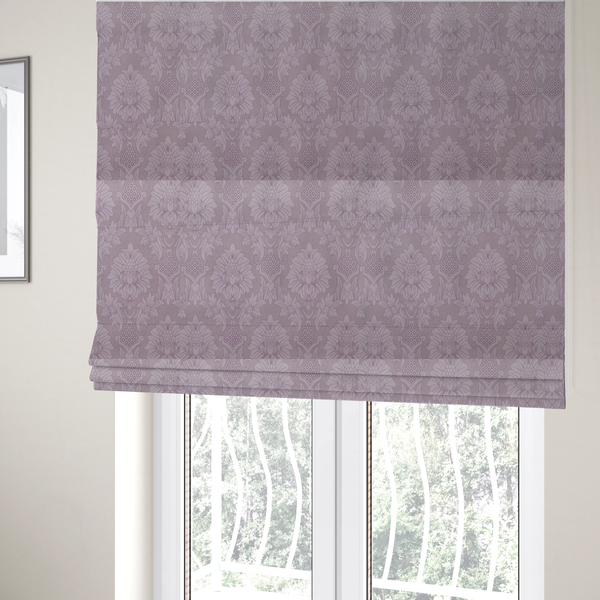 The fabric used to create these Roman blinds is a elegant lavender damask fabric featuring a large-scale, repeating floral and acanthus leaf pattern in a soft tonal lilac colourway.