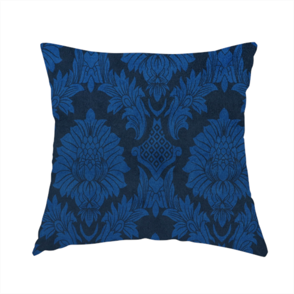 The fabric used to create this handmade cushion is a high-contrast damask fabric featuring a vibrant royal blue floral medallion pattern over a deep navy blue background.