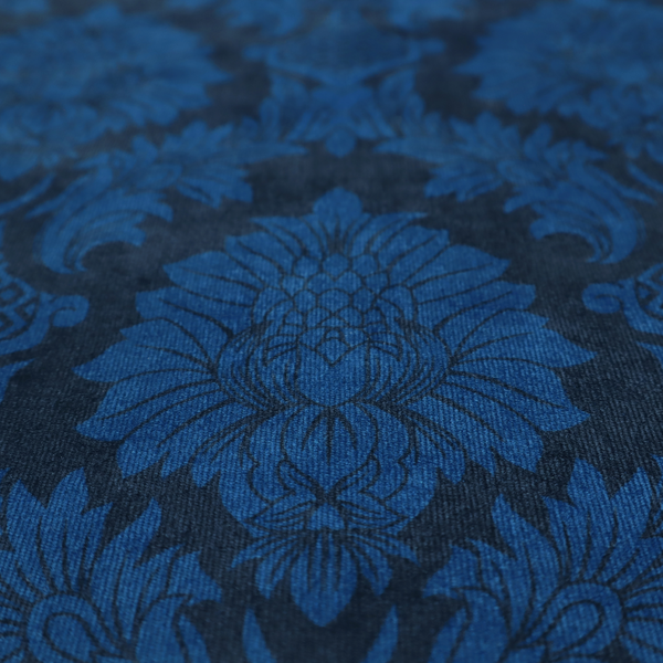 High-contrast damask fabric featuring a vibrant royal blue floral medallion pattern over a deep navy blue background.