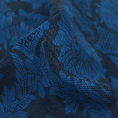 High-contrast damask fabric featuring a vibrant royal blue floral medallion pattern over a deep navy blue background.