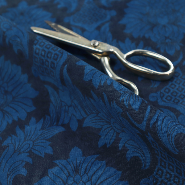 High-contrast damask fabric featuring a vibrant royal blue floral medallion pattern over a deep navy blue background.