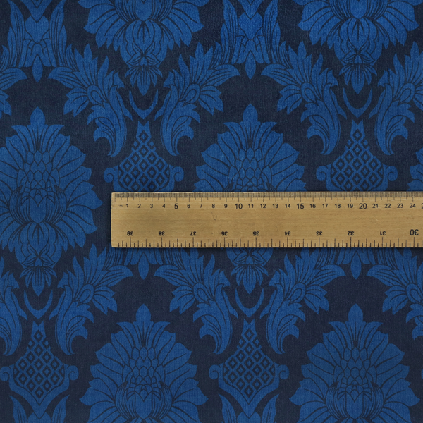 High-contrast damask fabric featuring a vibrant royal blue floral medallion pattern over a deep navy blue background.
