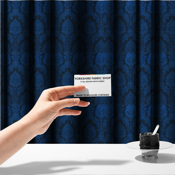 The fabric used to create these made-to-measure curtains is a high-contrast damask fabric featuring a vibrant royal blue floral medallion pattern over a deep navy blue background.