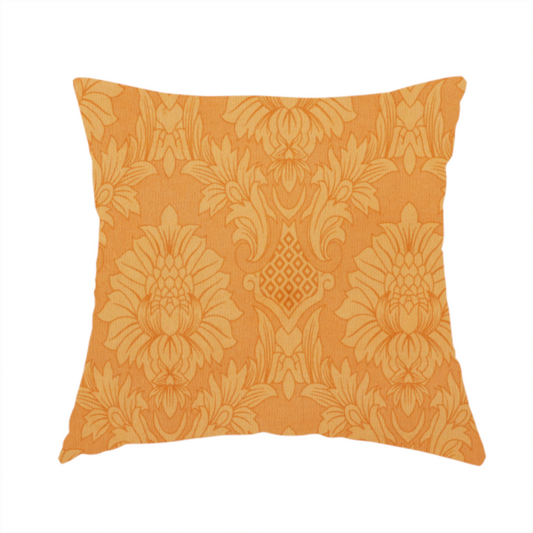 The fabric used to create this handmade cushion is a bright apricot-orange damask fabric with a large-scale, repeating floral and acanthus leaf pattern in a soft tonal colourway.