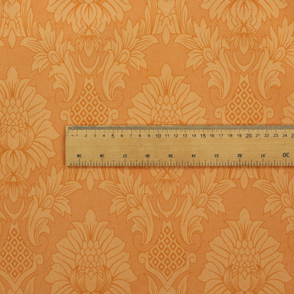 A bright apricot-orange damask fabric with a large-scale, repeating floral and acanthus leaf pattern in a soft tonal colourway.