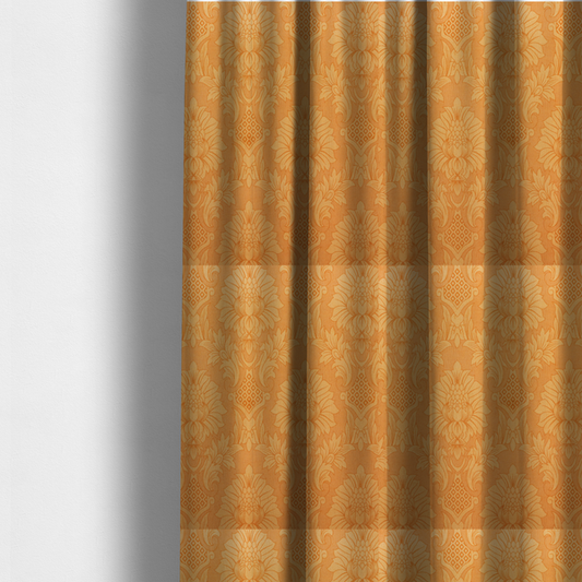 The fabric used to create these made-to-measure curtains is a bright apricot-orange damask fabric with a large-scale, repeating floral and acanthus leaf pattern in a soft tonal colourway.