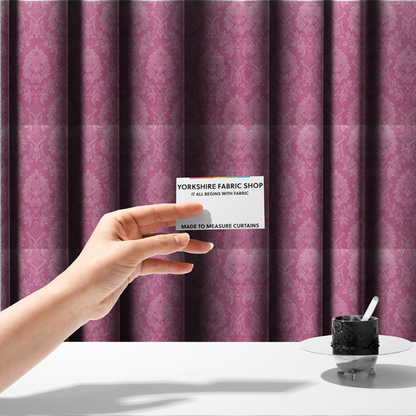 The fabric used to create these made-to-measure curtains is a vibrant magenta damask fabric featuring a large-scale, repeating floral and acanthus leaf pattern in a tonal, hot pink colourway.