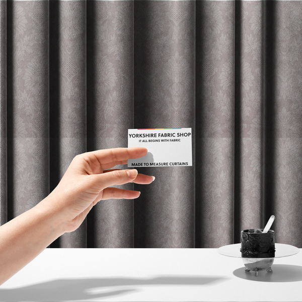 The fabric used to create these made-to-measure curtains is a subtle champagne and taupe damask fabric featuring a large-scale, repeating floral medallion pattern in a soft, shimmering tonal colourway.