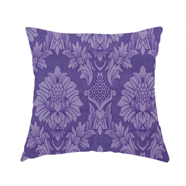 The fabric used to create this handmade cushion is a regal royal purple damask fabric featuring a large-scale, repeating floral and acanthus leaf pattern in a shimmering tonal violet colourway.